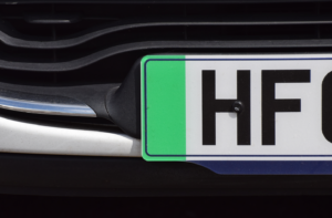 The green strip on a British car front number plate that denotes the car is a zero emissions vehicle. Ev sales UK