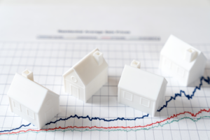 UK rent inflation slows. house models on graph indicating rental prices trend for the UK house market.