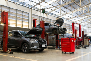 car in automobile repair service center with soft-focus and over light in the background. Biggest Challenges Facing Garages in 2025. Motor Repair Industry.